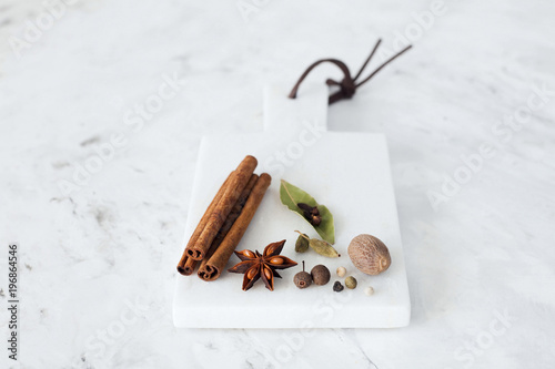 spices on a white marble background