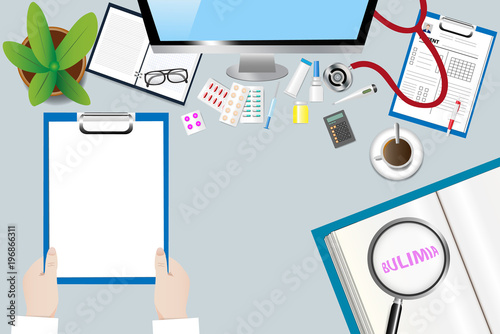 Top view of a medical table with doctor accessories. Doctor is holding blank paper ready for your text. The magnifying glass magnifies the inscription Bulimia in an open book.