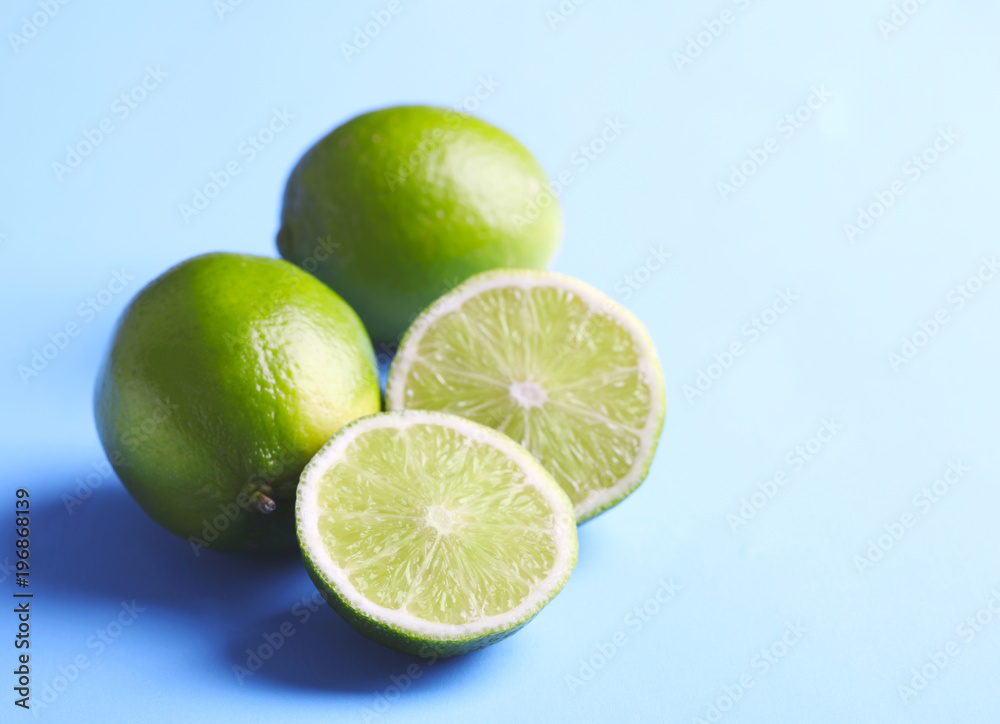 Fresh limes on light blue background