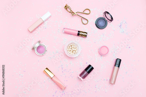 Cosmetics and accessories on a background of pink color. Flat lay