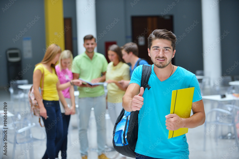 Portrait of a young student standing outside with friends in the background Portrait of a young student standing outside with friends in the background