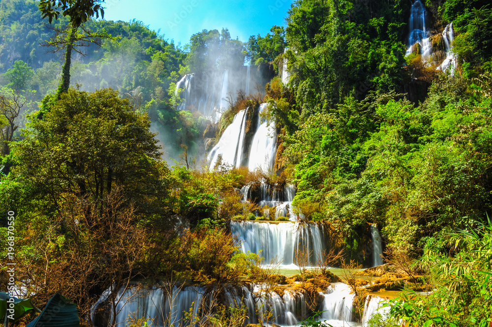 Beautiful Thi Lo Su waterfalls with foggy environment