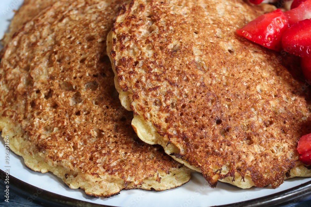 Homemade Oat wheat Bran Pancakes served with fresh strawberries and banana Homemade Oat wheat Bran Pancakes served with fresh strawberries and banana