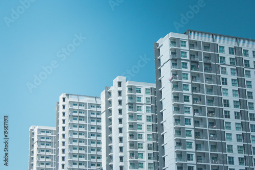 Architecture of row residential buildings with blue sky in the background.