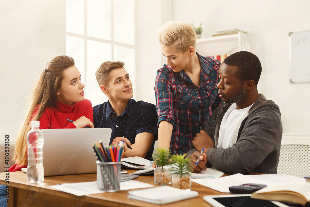 Multiethnic classmates preparing for exams together Multiethnic classmates preparing for exams together