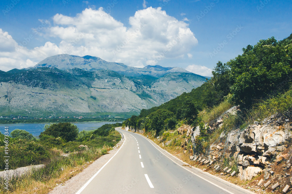 Scenic road landscape with mountains in the background. Scenic road landscape with mountains in the background.