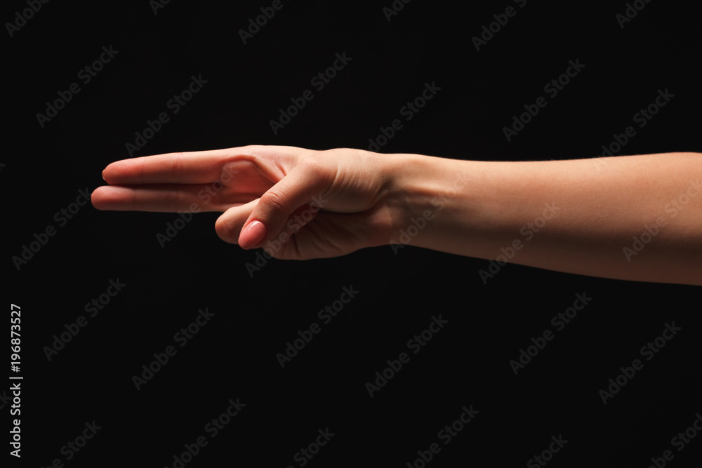 Female hand shows number two isolated at black Female hand shows number two isolated at black