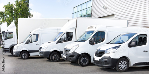 Fotografie, Obraz Several cars vans trucks parked in parking lot for rent or delivery