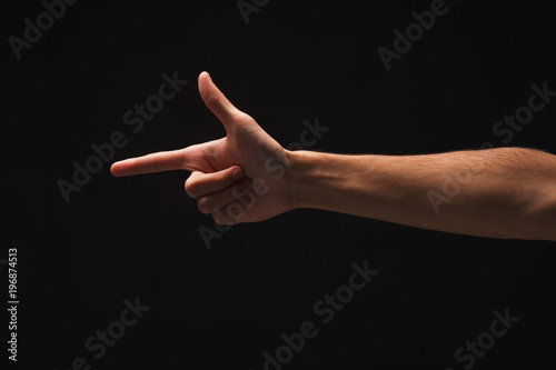 Hand gestures - man pointing, isolated at black