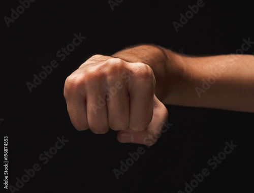 Male fist on black background