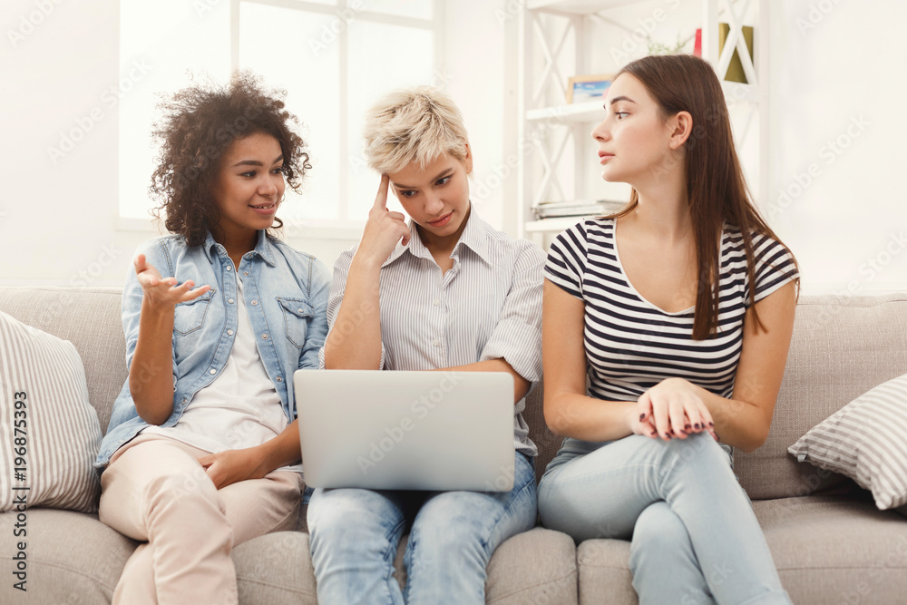 Three sad women using laptop at home Three sad women using laptop at home