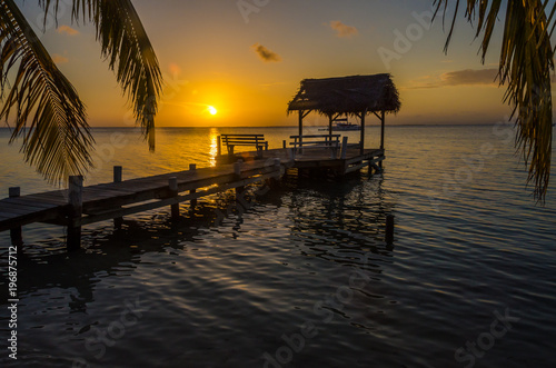 Fototapeta Naklejka Na Ścianę i Meble -  Sunset at South Water Caye - Small tropical island at Barrier Reef with paradise beach - known for diving, snorkeling and relaxing vacations - Caribbean Sea, Belize, Central America