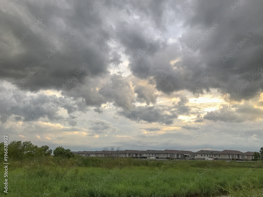 dark grey clouds before storm and grass field dark grey clouds before storm and grass field