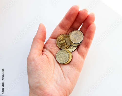Russian coins in a hand on a white background