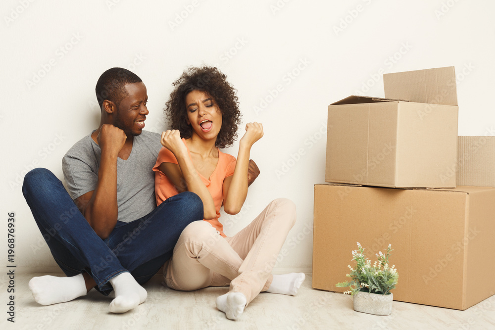 Black couple sitting on floor at new apartment Black couple sitting on floor at new apartment