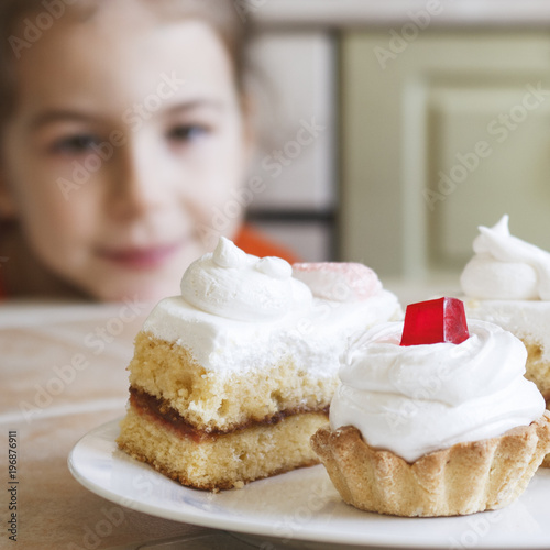 A little girl is eager to eat a delicious cake