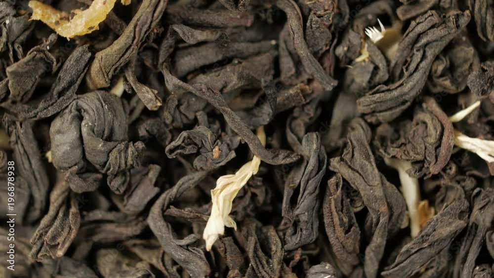 Black tea leaves close up top view. Loop rotation. In the front of the camera rotates plate black tea. Black tea leaves close up top view. Loop rotation. In the front of the camera rotates plate black tea.
