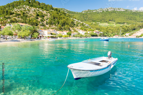 amazing crystal clear sea with boat and beach in Peljesac peninsula, Dalmatia, Croatia