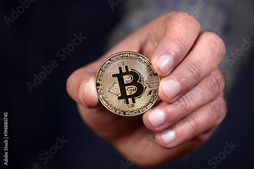hand holding a bitcoin