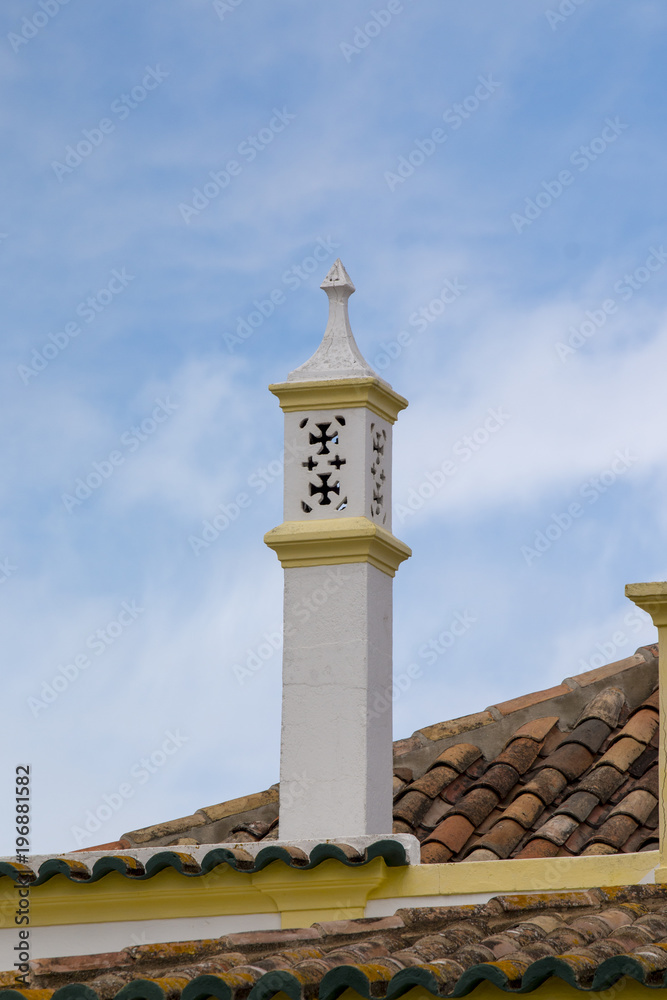 Portuguese chimney on a brown tile roof