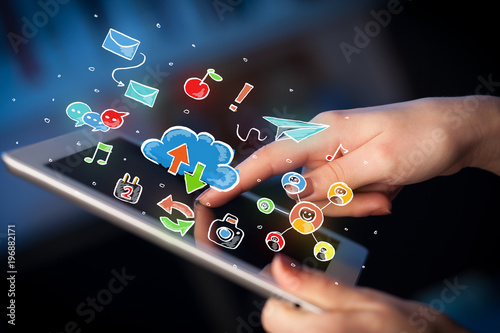 Fingers touching tablet with social icons