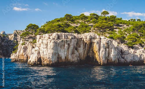 White cliffs of Massif des Calanques covered with lush pine trees in Cassis near Marseille, France