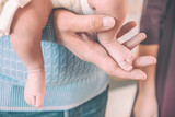 Newborn baby's feet and man's hand. Epiphany.
