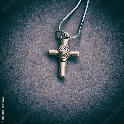 Silver cross on a gray background