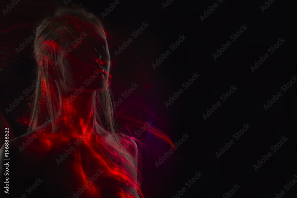 Conceptual avant-garde silhouette portrait of a beautiful blonde girl covered with multicolored lines applied by a lightbrush Conceptual avant-garde silhouette portrait of a beautiful blonde girl covered with multicolored lines applied by a lightbrush