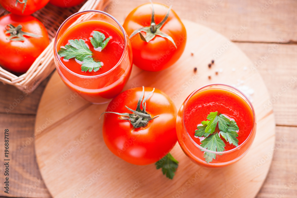 Glasses of fresh tomato juice and tomatoes Glasses of fresh tomato juice and tomatoes