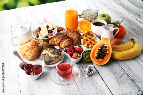 Breakfast served with coffee, orange juice, croissants and fruits. Balanced diet.
