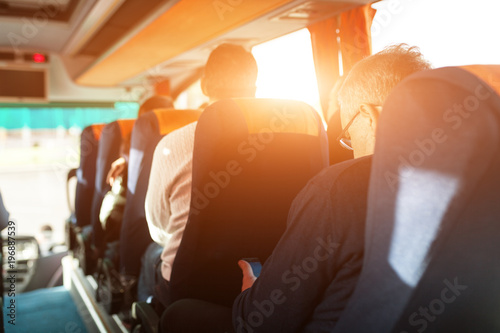 interior of bus with passengers rear view