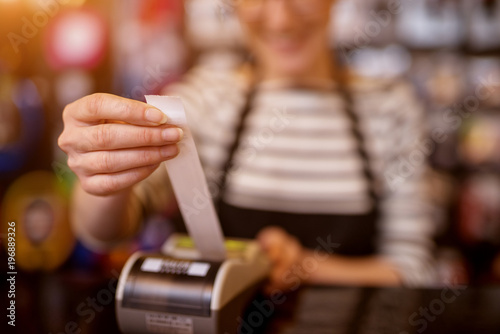 Close up focus view of woman while pulling out a check from the cashier