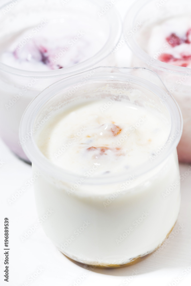 assortment of yogurts with fruit additives, vertical closeup assortment of yogurts with fruit additives, vertical closeup