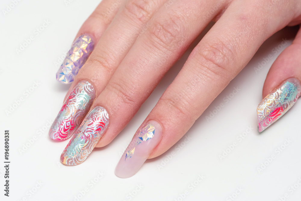 Nail Design. Close-up. Stylish manicured hands and glittery color against a white background Nail Design. Close-up. Stylish manicured hands and glittery color against a white background
