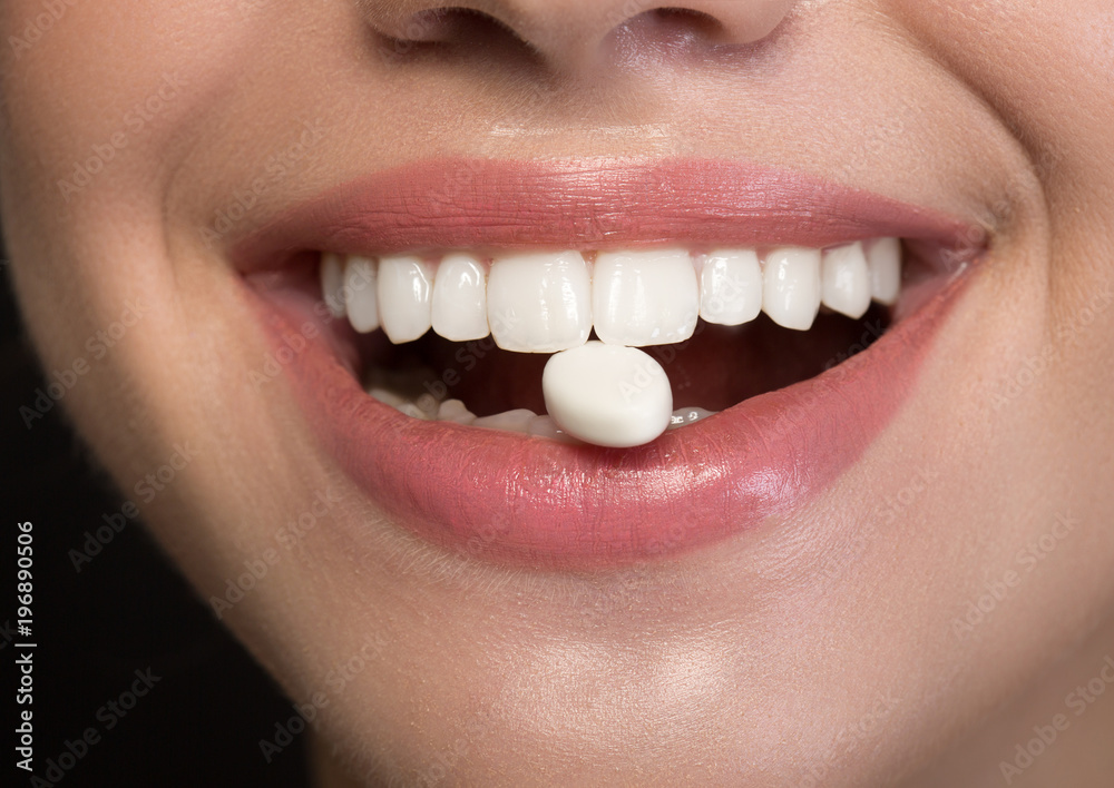 Joyful girl is showing white healthy teeth with chewing gum into mouth.  Fresh breath concept. Close up Stock Photo | Adobe Stock