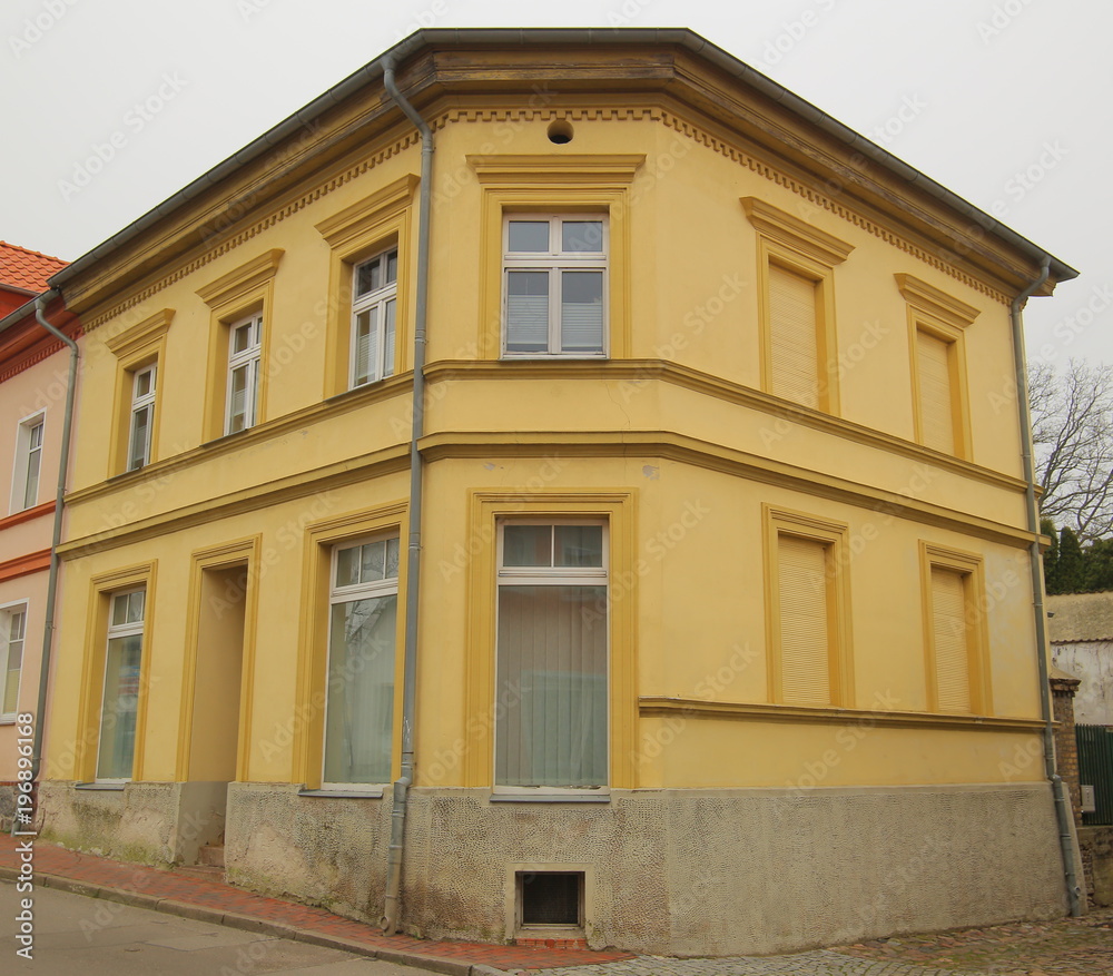 Yellow corner house listed as monument in Guetzkow, Mecklenburg-Vorpommern, Germany
