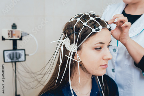 Doctor and patient with encephalography electrode. photo