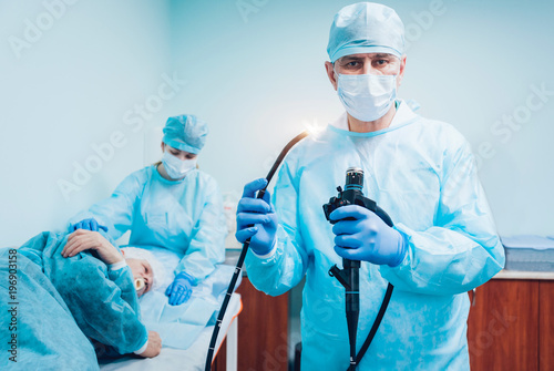 Endoscopy at the hospital. Doctor holding endoscope before gastroscopy photo