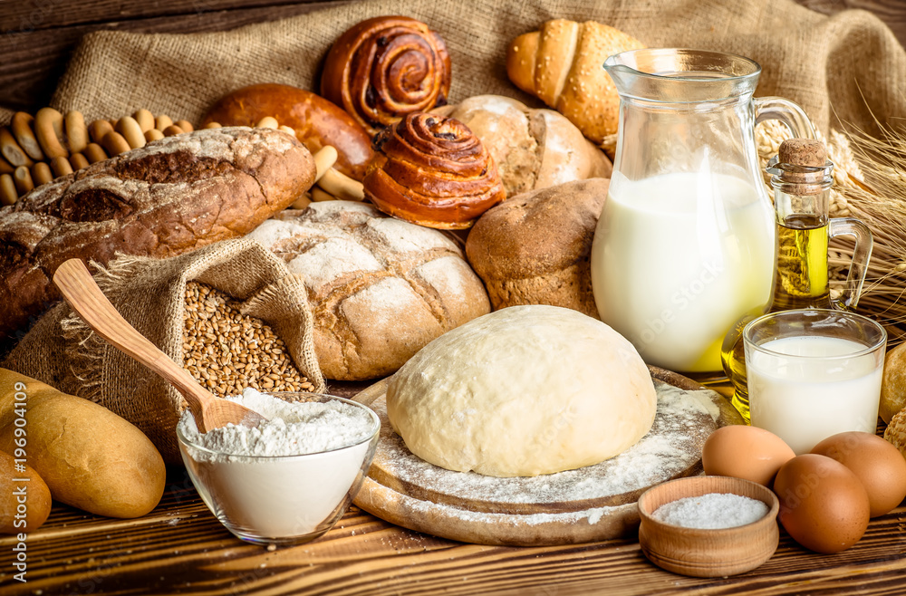 Assortment of baked bread on wooden table background Assortment of baked bread on wooden table background