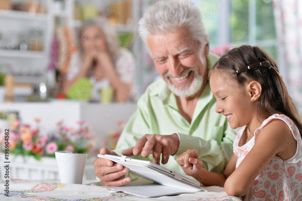 grandfather with granddaughter using laptop grandfather with granddaughter using laptop