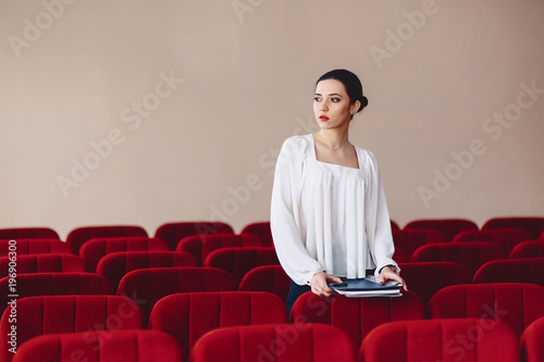 woman looks aside of seats between armchairs