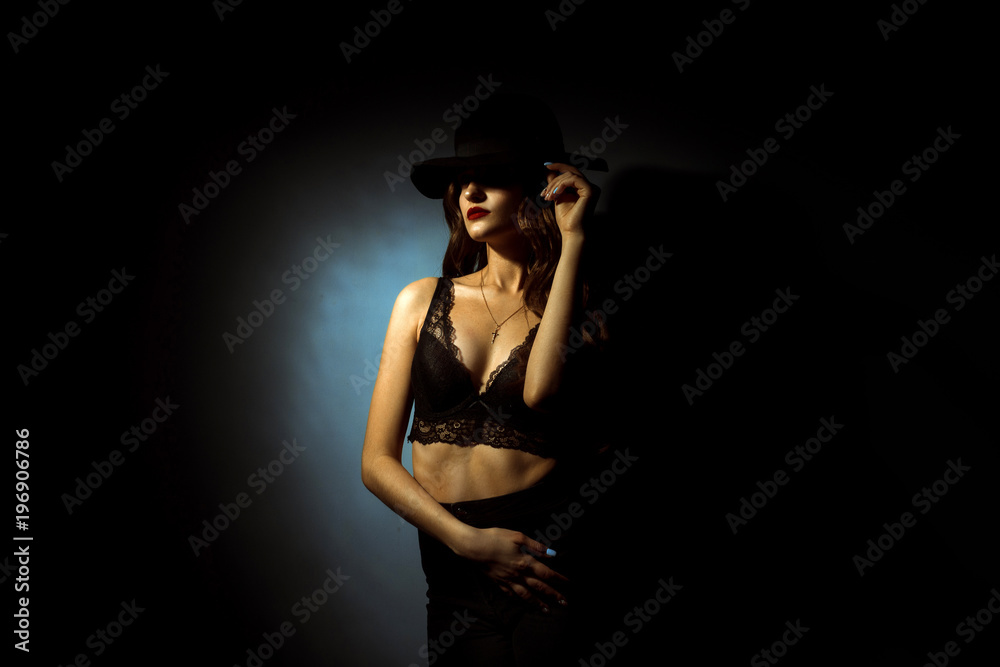 Gorgeous lady with curly hairstyle in dark studio Gorgeous lady with curly hairstyle in dark studio