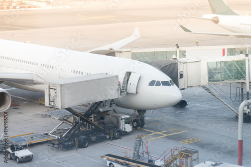Jet aircraft docked in international airport. special truck unloads cargo from the aircraft