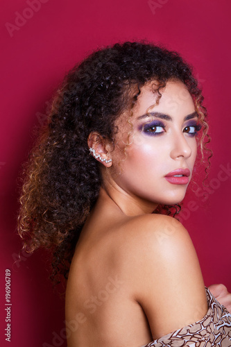 Close-up portrait of a beautiful young african american female fashion model with curly hair