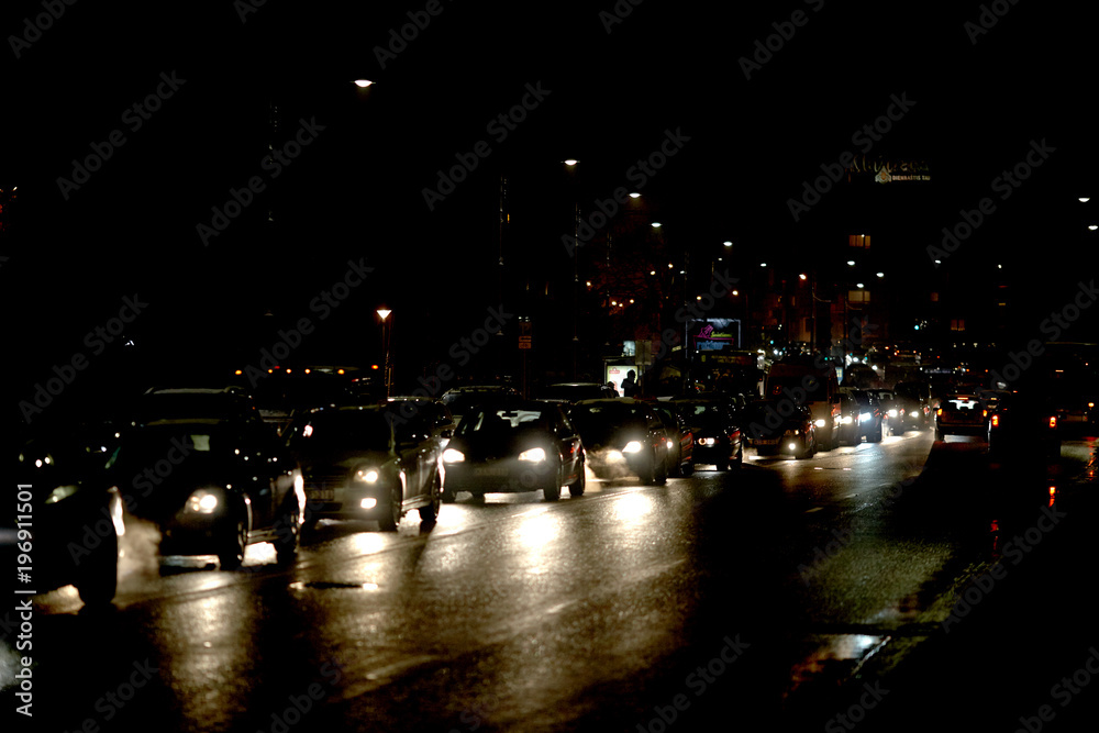 image of traffic at night and from various lights and lights from cars running on the street.