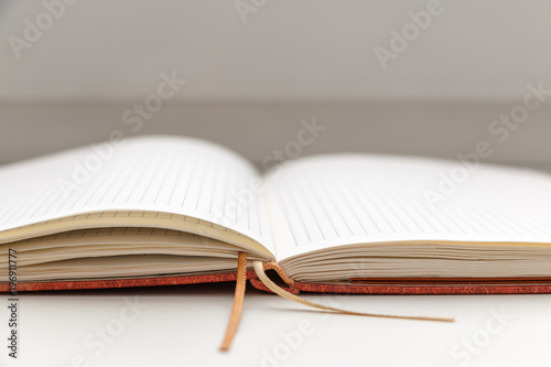 Open blank notepad on white background close-up