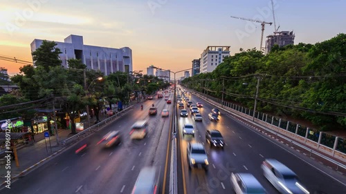 4k Day to Night Time-lapse of traffic on Ngamwongwan Road at Kasetsart University in bangkok, Thailand photo