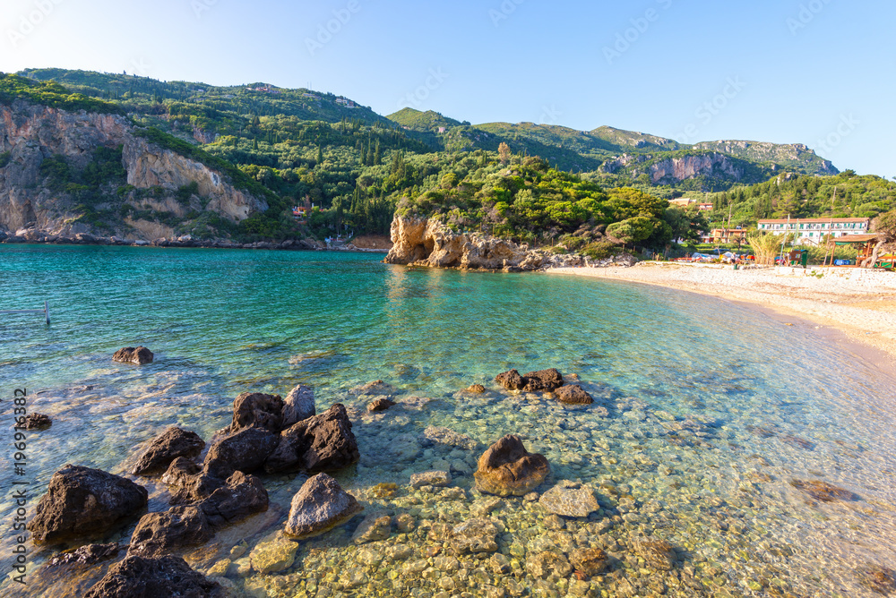 Fototapeta premium Paleokastritsa bay with sand and crystal sea water. Corfu island, Greece.