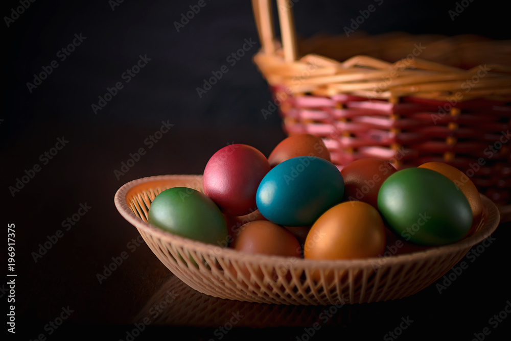 Naklejka premium Painted multi-colored paint Easter eggs with a basket